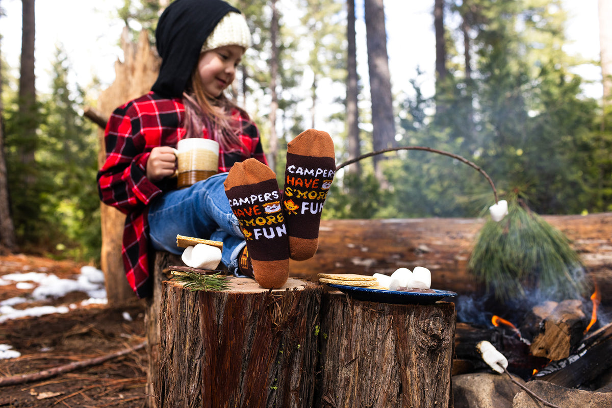 Child wearing Lavley s'mores socks at a campsite